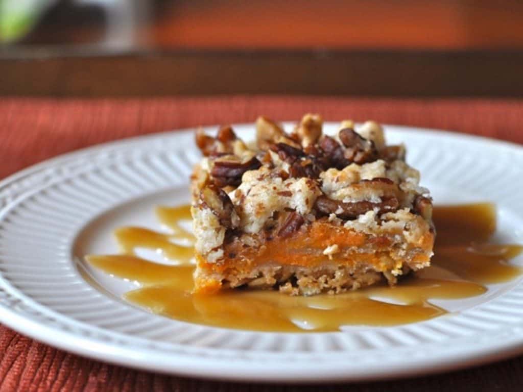 Spirited Southern Sweet Potato Bar served on a dessert plate drizzled with caramel sauce.