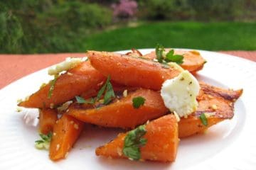 A serving of Roasted Carrots with Feta and Thyme on a plate.