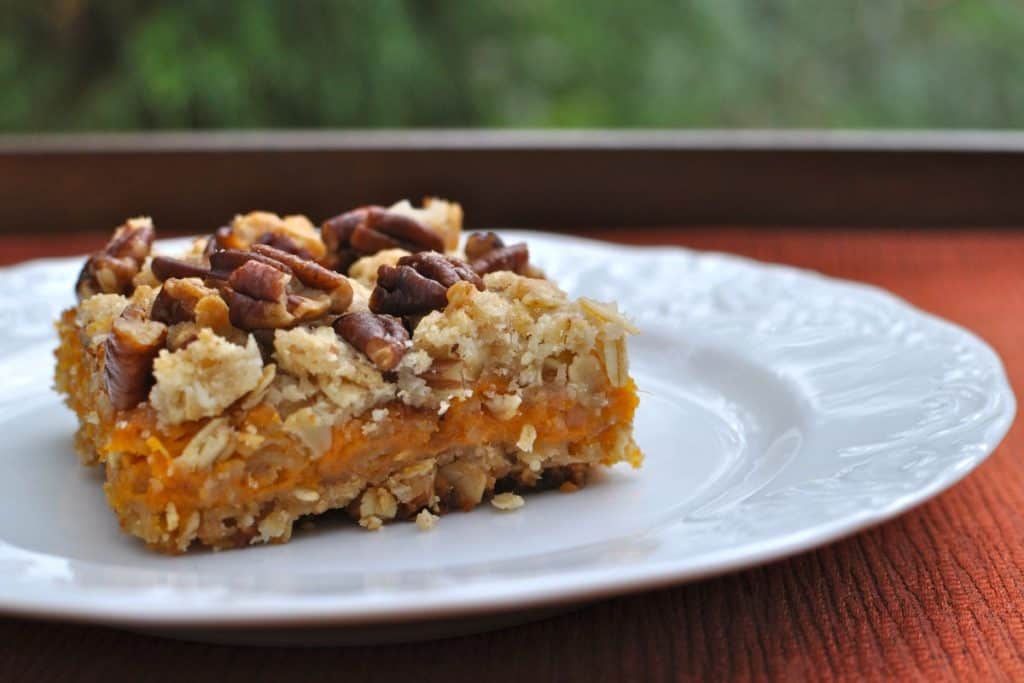 A Spirited Southern Sweet Potato Bar topped with toasted pecans served on a plate.