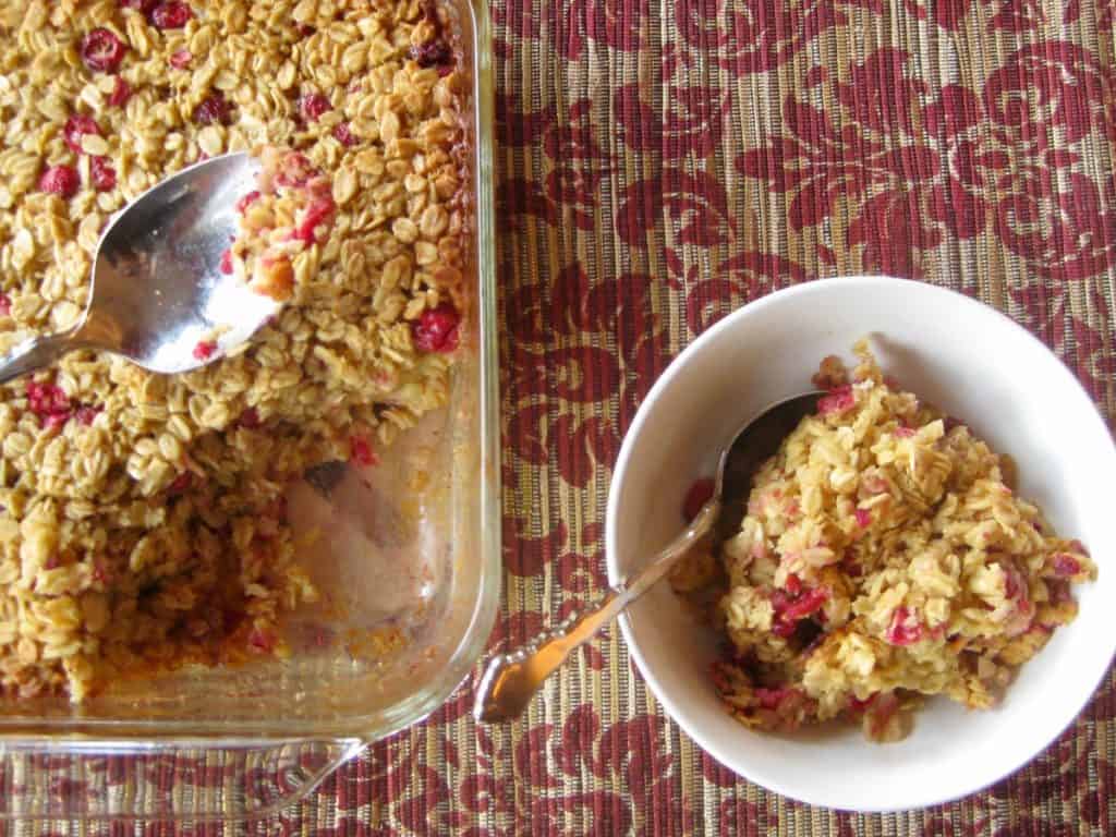 Cranberry Orange Baked Oatmeal scooped from a serving dish into an individual bowl.