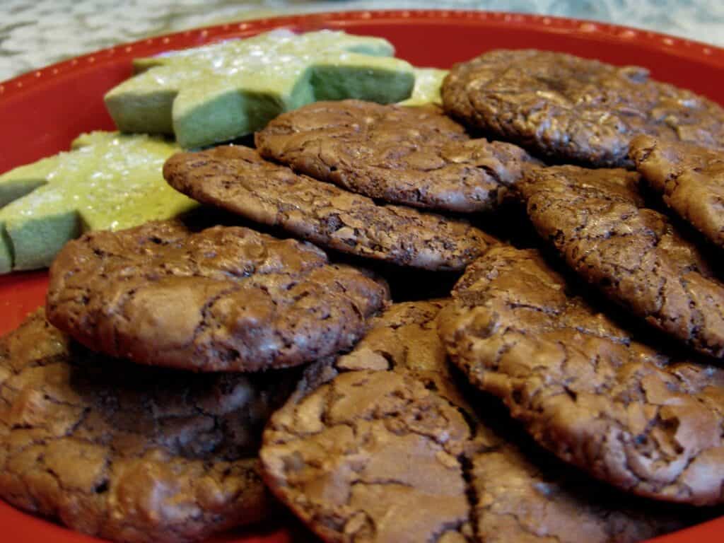 Hazelnut Truffle Cookies arranged on a plate with Matcha Shortbread Cutout Cookies.