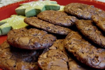 Hazelnut Truffle Cookies arranged on a plate with Matcha Shortbread Cutout Cookies.