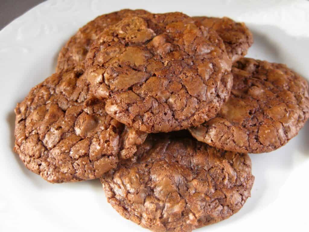 Hazelnut Truffle Cookies are stacked on a white plate.