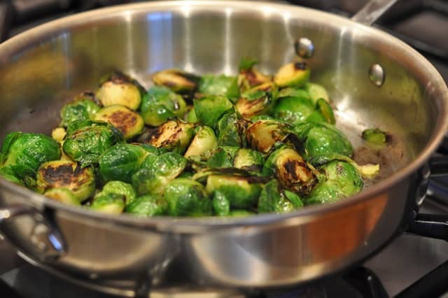 Pan-Roasted Brussels Sprouts cooked until they are deep brown in a skillet.