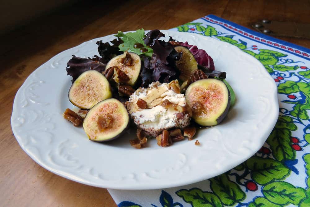 Fig Salad Dressed in Balsamic and Honey served on a white plate with a French napkin