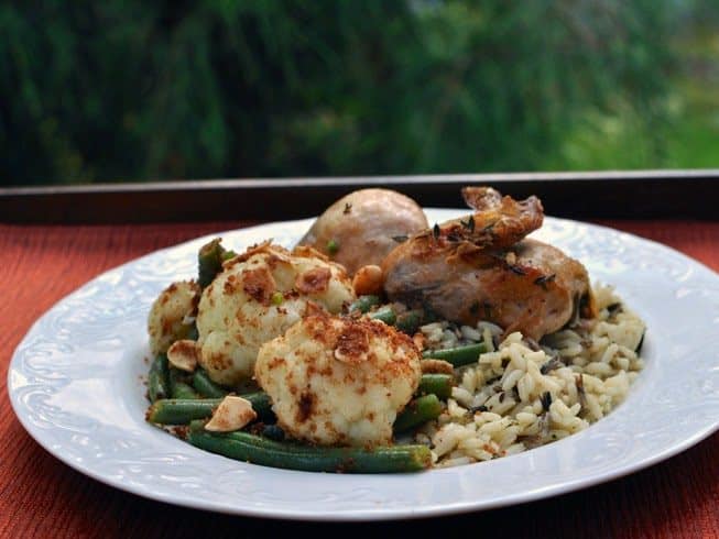Cauliflower and Green Beans with Buttered Nuts and Crumbs on a plate with Chicken and Rice Pilaf