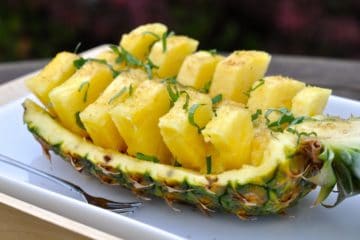 Party Pineapple cut into pieces and served in the pineapple shell.
