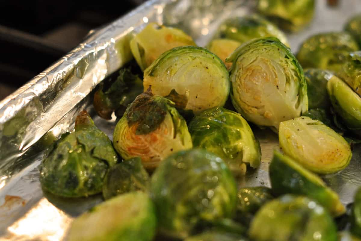 Halved Brussels Sprouts roasted on a sheet pan.