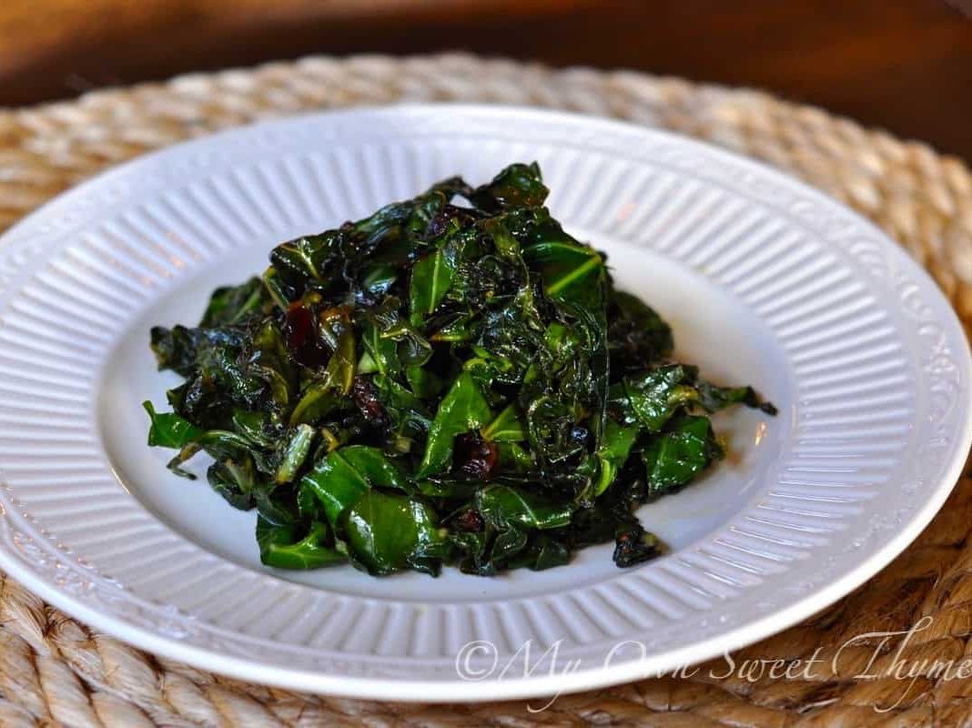A serving of Quick Collard Greens with Cranberries on a white plate.