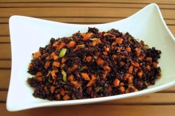 Black Rice with Gingered Sweet Potatoes served in an asymmetrical white bowl.