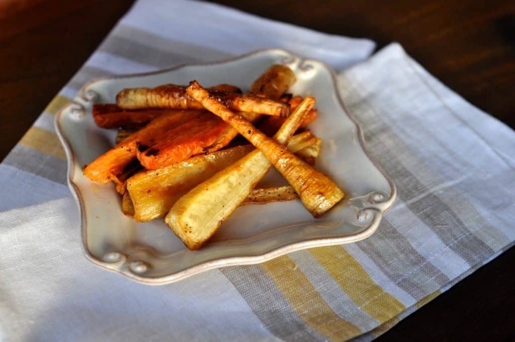 Honey Roasted Parsnips with carrots served on a small square plate.