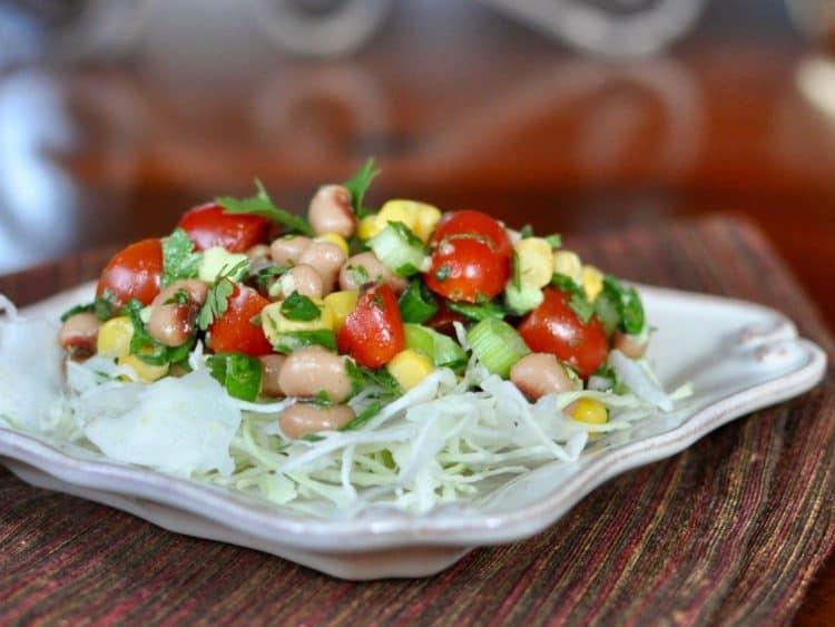 Cowboy Caviar on a bed of angel hair cole slaw served on a square plate