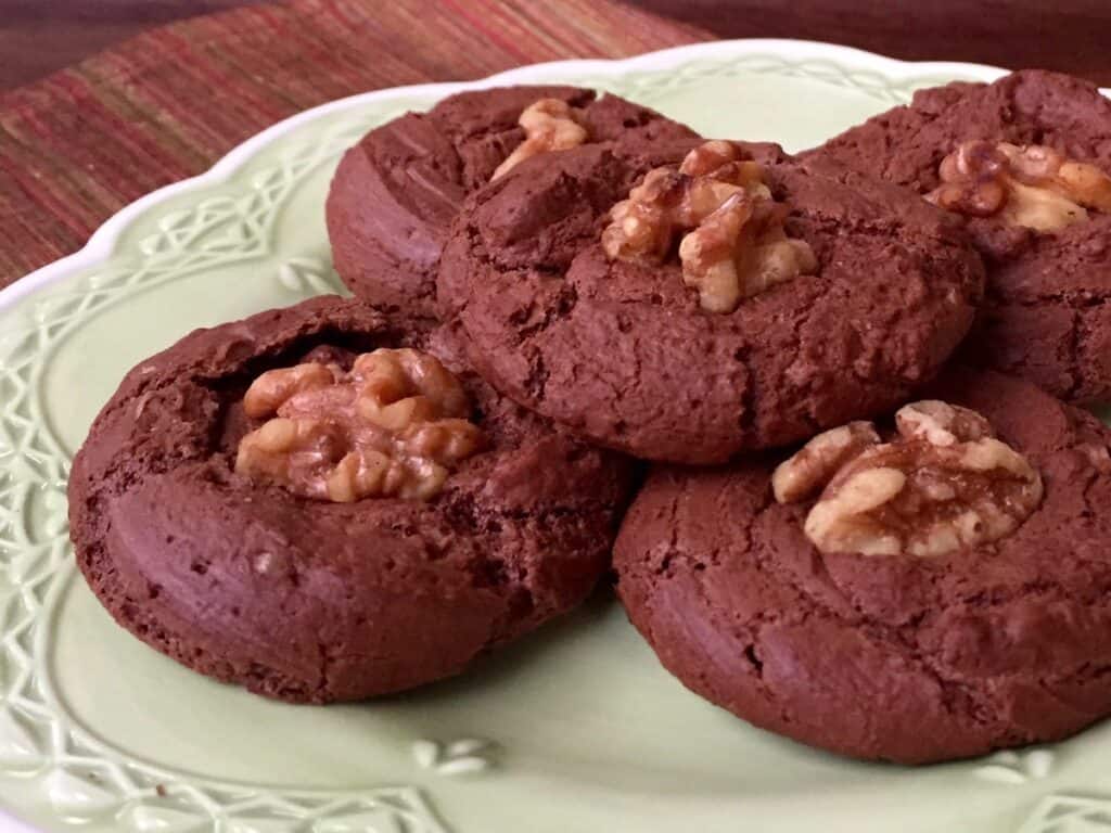 Chewy Chocolate Meringue Cookies piled on a green plate.