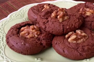 Chewy Chocolate Meringue Cookies piled on a green plate.