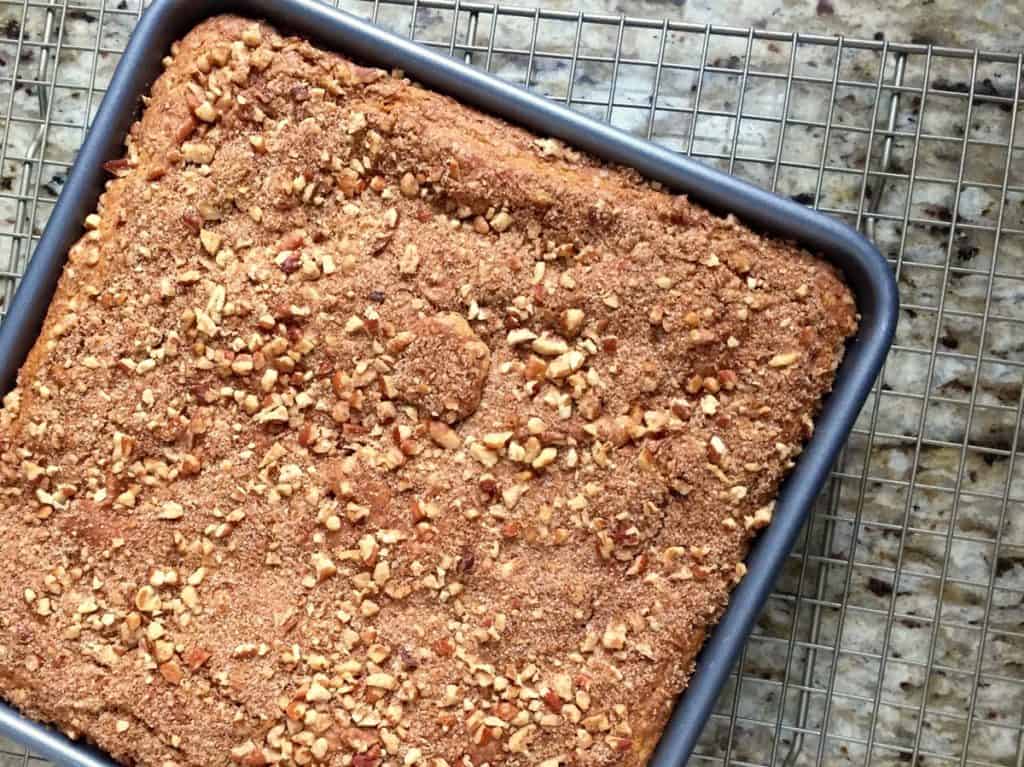 Sour Cream Cinnamon Coffee Cake baked in a 9-inch square pan and cooling on a wire rack.