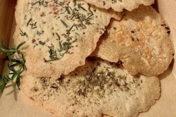 Sourdough Cracker Leaves on a wood tray garnished with a sprig of rosemary.