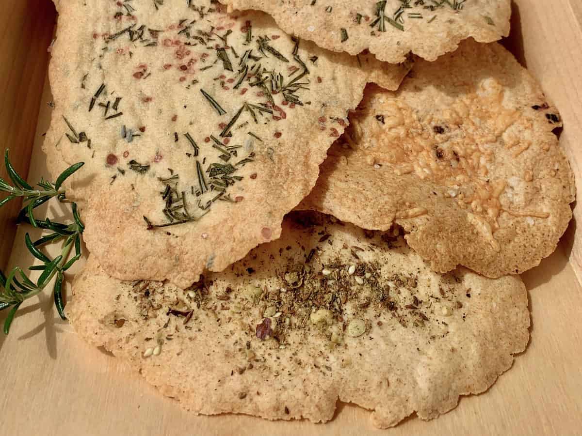 Sourdough Cracker Leaves on a wood tray garnished with a sprig of rosemary.