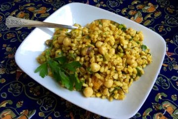 Moroccan Chickpea and Barley Salad on a a square plate with antique silver serving spoon.