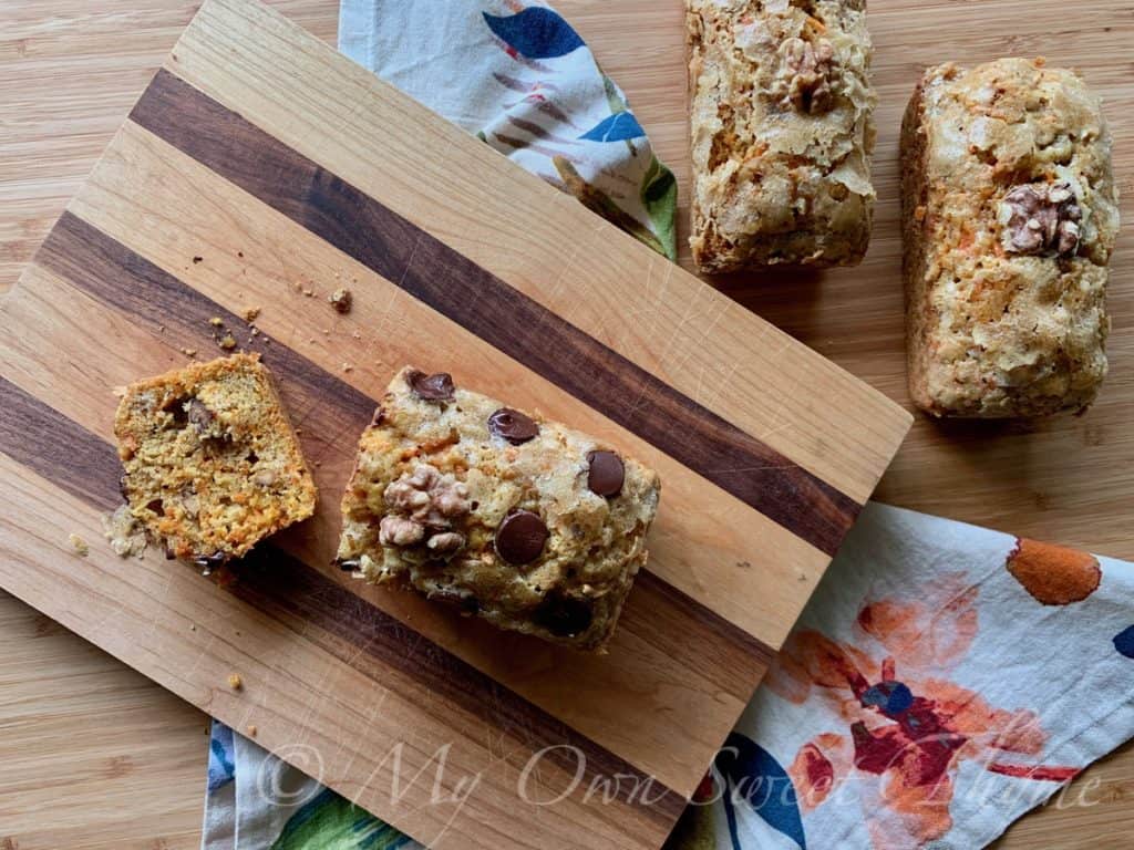 Carrot Cake Bread loaves, some dotted with chocolate chips and garnished with walnut halves
