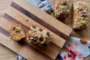 Carrot Cake Bread loaves, some dotted with chocolate chips and garnished with walnut halves.