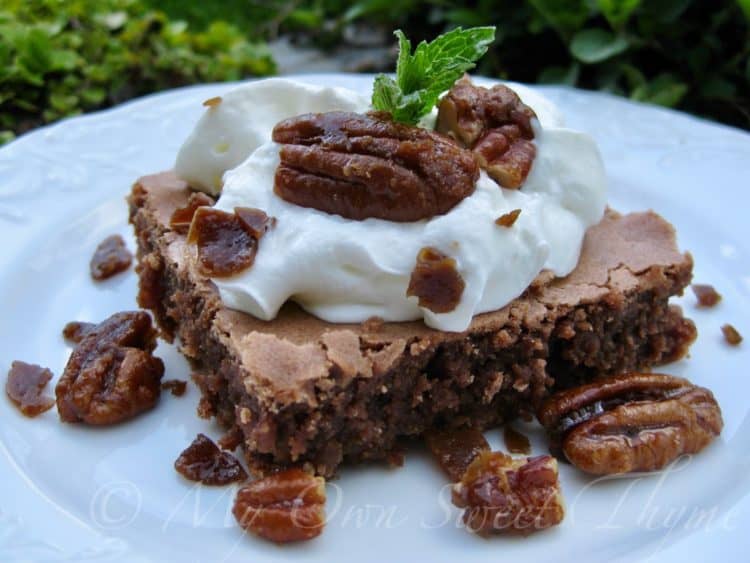 Mint Julep Brownie topped with whipped cream and whole pecans and garnished with a mint leaf