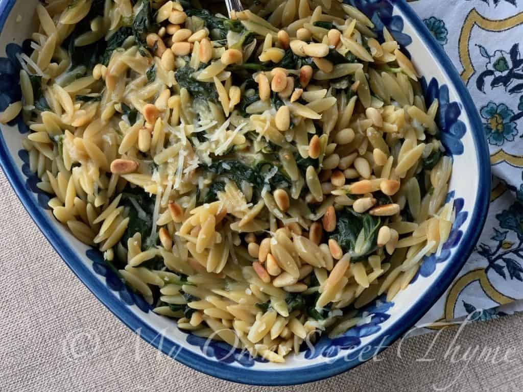 Orzo with Spinach and Pine Nuts in a pretty serving dish from Louisville Stoneware