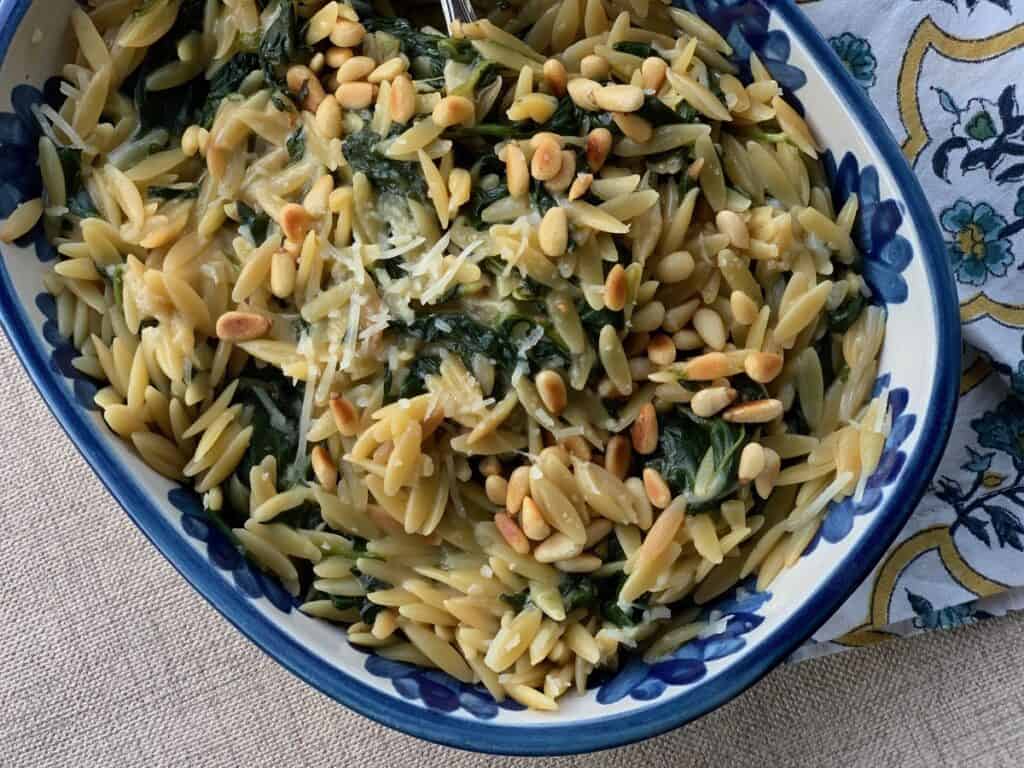 Orzo with Spinach and Pine Nuts in a pretty dish from Louisville Stoneware.