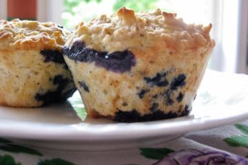 Blueberry Oat Muffins on a white plate atop an antique napkin