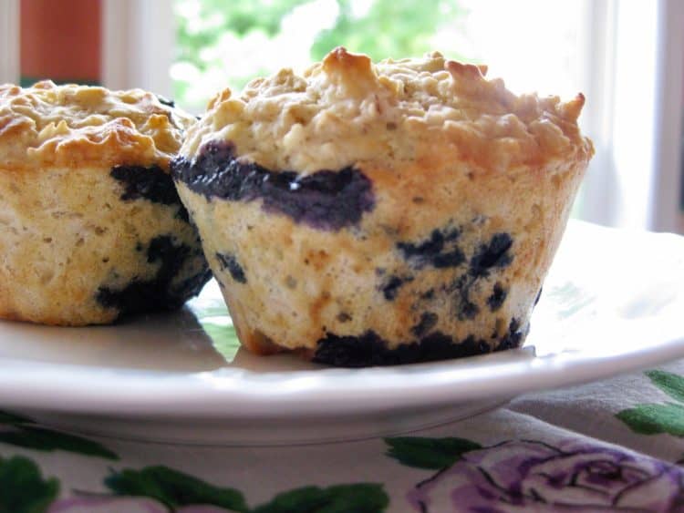 Blueberry Oat Muffins on a white plate atop an antique napkin