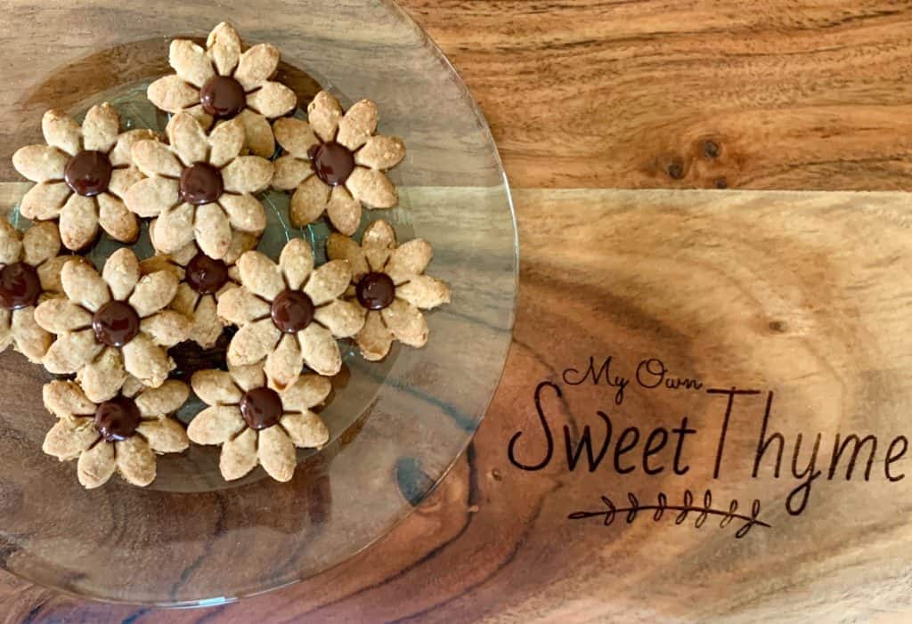 Chocolate- Covered Digestive Cookies shaped like flowers on My Own Sweet Thyme serving board