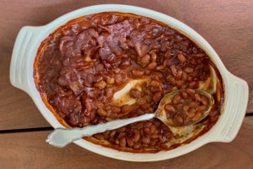Bourbon Baked Beans in Casserole with serving spoon