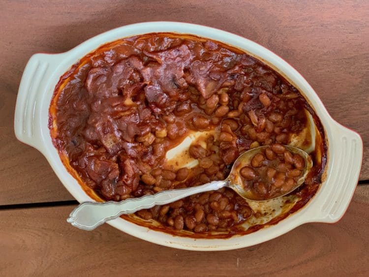 Bourbon Baked Beans in Casserole with serving spoon