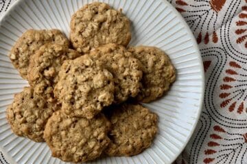 Aunt Betty's Spicy Oatmeal Cookies stacked on a white plate.