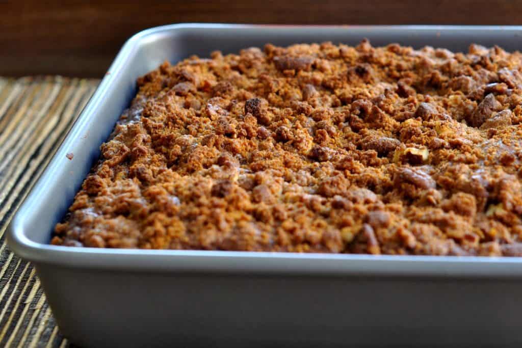 A 9-inch square pan filled with a freshly baked Gingerbread Streusel Coffee Cake.