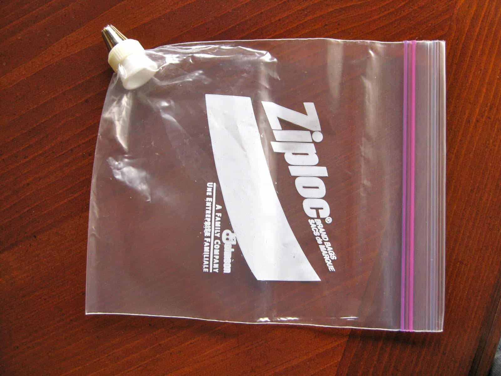 A Ziploc bag with a decorating coupler and piping tip attached.