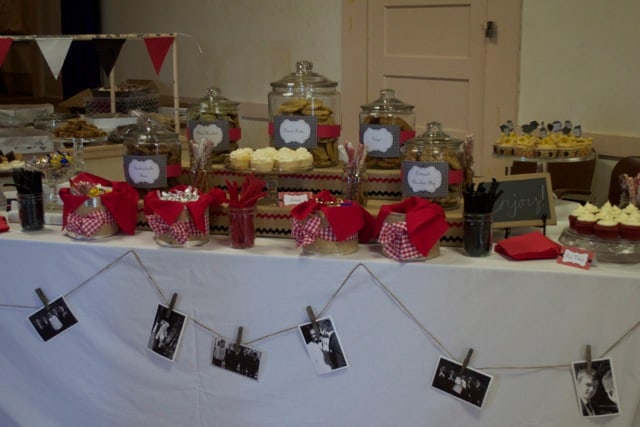 graduation party dessert table with gingham lined baskets and draped twine photo display